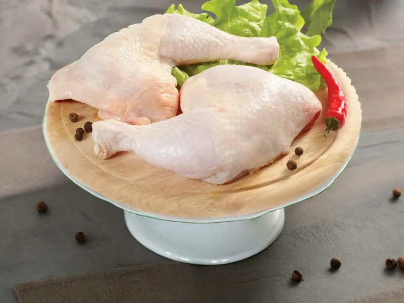Two raw chicken leg quarters